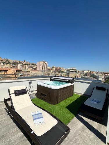 a hot tub on the roof of a building at 18 Dante Luxury Suites in Cagliari