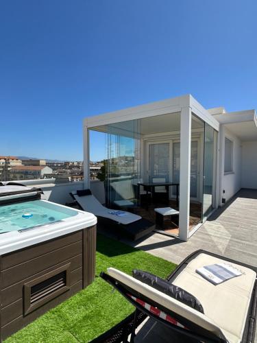 a house with a swimming pool on a roof at 18 Dante Luxury Suites in Cagliari