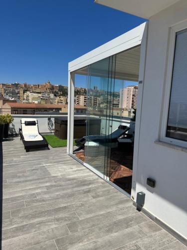 a balcony with sliding glass doors on a building at 18 Dante Luxury Suites in Cagliari