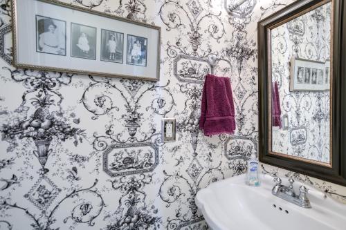 a bathroom with a white sink and a mirror at Charming St Petersburg Bungalow 2 Mi to Downtown! in St Petersburg