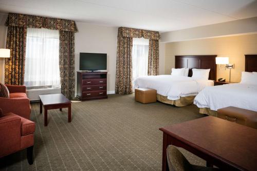a hotel room with two beds and a television at Hampton Inn & Suites Toledo-Perrysburg in Rossford