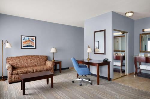 a room with a couch and a desk and a chair at Hampton Inn & Suites Tulsa South Bixby in Tulsa