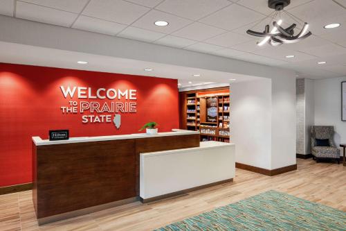 a welcome to the prairie state sign in a lobby at Hampton Inn & Suites Chicago/Waukegan in Waukegan