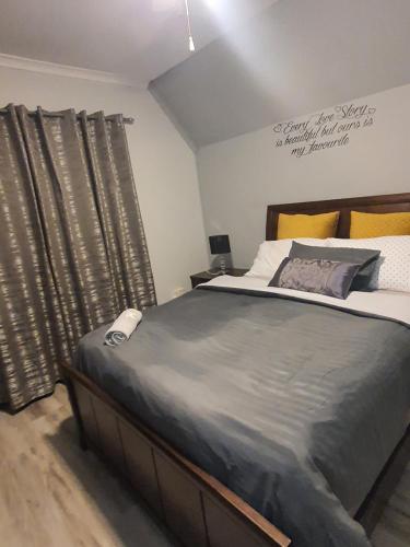 a bedroom with a large bed with gray sheets at 67@18th Avenue Beach View, in East London
