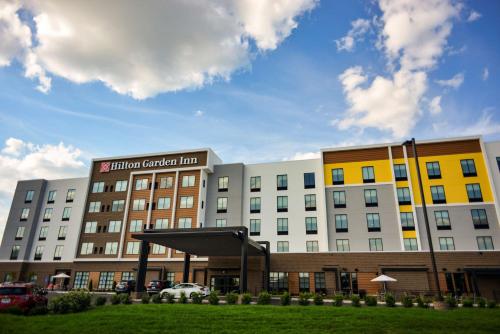 a building with a sign for a hotel at Hilton Garden Inn Louisville Mall Of St. Matthews in Louisville