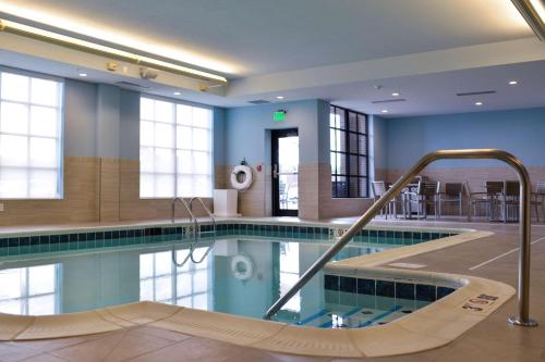 a swimming pool with a slide in a building at Hilton Garden Inn Louisville Mall Of St. Matthews in Louisville