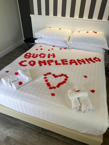 a bed with red hearts and towels on it at 18 Dante Luxury Suites in Cagliari