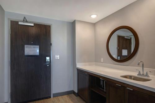 a bathroom with a sink and a mirror at Hampton Inn Santa Fe South, NM in Santa Fe