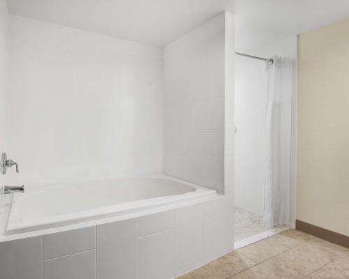 a white bathroom with a tub and a shower at Hilton Garden Inn Las Vegas/Henderson in Las Vegas