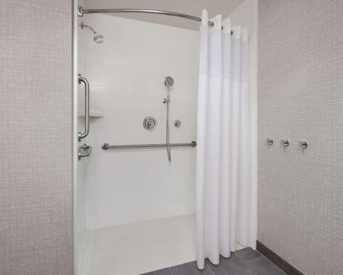 a shower with a shower curtain in a bathroom at Hampton Inn & Suites West Haven in West Haven