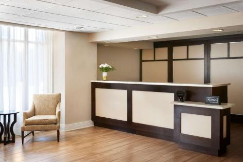 a waiting room with a chair and a counter at Homewood Suites by Hilton Baltimore-Washington Intl Apt in Linthicum Heights