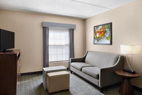 a living room with a couch and a television at Homewood Suites by Hilton Baltimore-Washington Intl Apt in Linthicum Heights