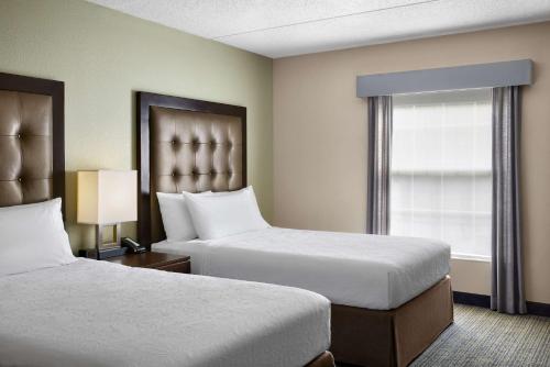 a hotel room with two beds and a window at Homewood Suites by Hilton Baltimore-Washington Intl Apt in Linthicum Heights