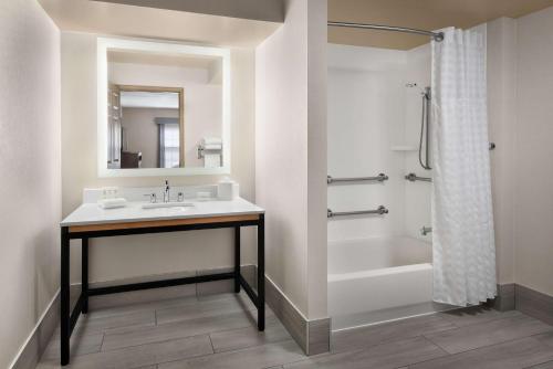 a bathroom with a sink and a tub and a shower at Homewood Suites by Hilton Baltimore-Washington Intl Apt in Linthicum Heights