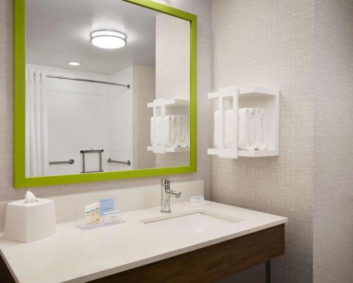 a bathroom with a sink and a large mirror at Hampton Inn Indianapolis Northwest - Park 100 in Indianapolis