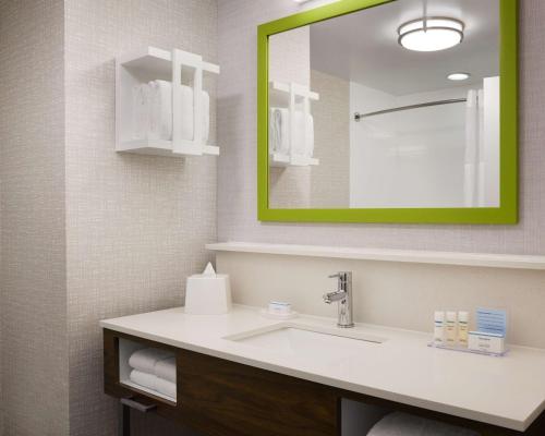 a bathroom with a sink and a mirror at Hampton Inn Indianapolis Northwest - Park 100 in Indianapolis