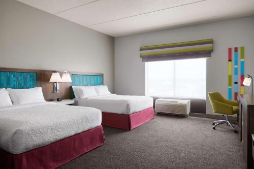 a hotel room with two beds and a window at Hampton Inn Indianapolis Northwest - Park 100 in Indianapolis