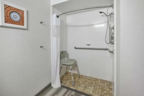 a shower with a chair in a bathroom at Hampton Inn Pittsburgh University Medical Center in Pittsburgh
