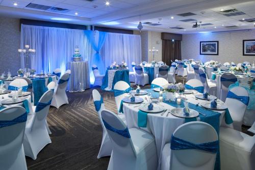 a banquet hall with tables and chairs in a room at Hilton Garden Inn Savannah Airport in Savannah