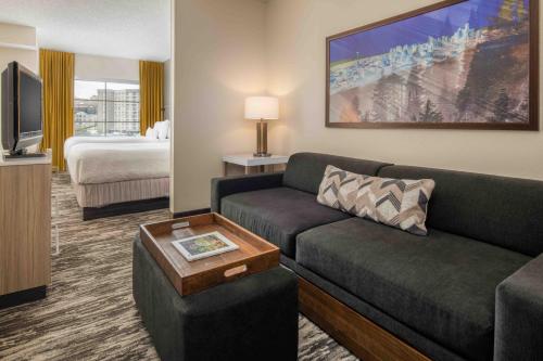a living room with a couch and a bed at SpringHill Suites Seattle Downtown in Seattle