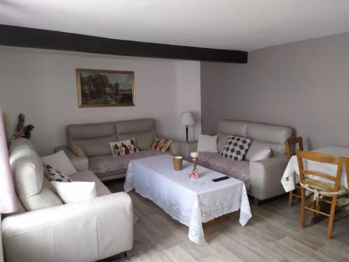 a living room with a couch and a table at La Maison De L'union in Gérardmer