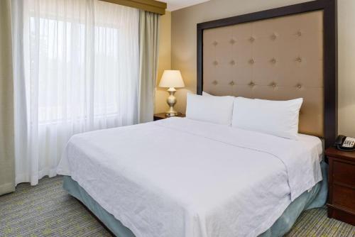 a bedroom with a large white bed and a window at Homewood Suites by Hilton Fresno in Fresno