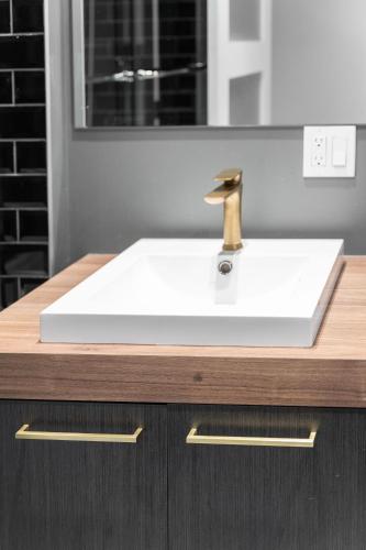 a white sink with a faucet on a counter at Le Sainte-Marie - Vieux-Terrebonne in Terrebonne
