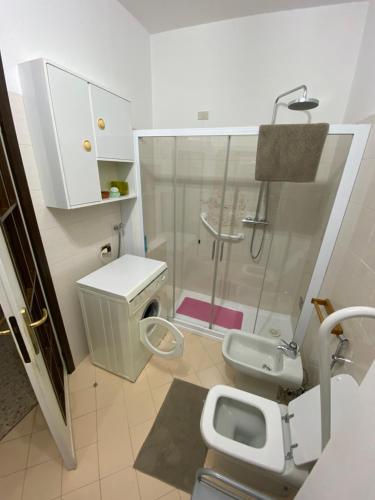 a bathroom with a shower and a toilet and a sink at La Casa Rosa by Roby&Silvy in Bellano