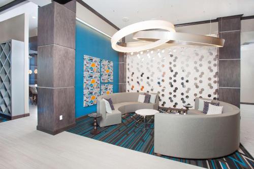 a lobby with a waiting room with a chandelier at Hampton Inn & Suites LAX El Segundo in El Segundo