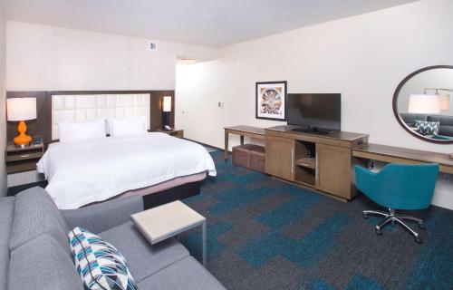 a hotel room with a bed and a couch at Hampton Inn & Suites LAX El Segundo in El Segundo