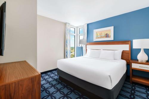 a hotel room with a bed and a desk at Homewood Suites by Hilton Myrtle Beach Oceanfront in Myrtle Beach