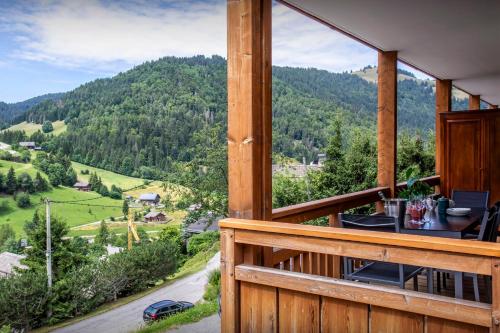 a view from the porch of a cabin with a mountain view at Loft Monte Clusio - OVO Network in La Clusaz