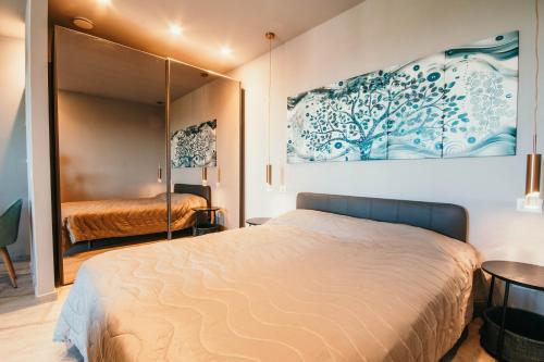 a bedroom with a bed and a painting on the wall at Appartamento Meda - Lakeside Leisure & Business in Cissano