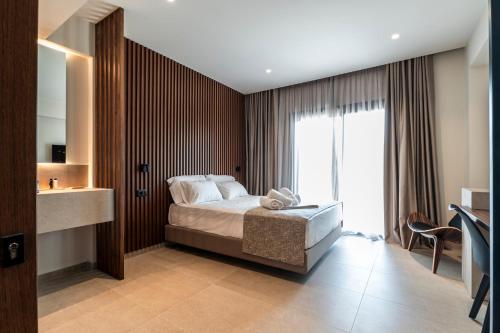 a bedroom with a bed and a large window at LANGO LUXURY LIVING s in Sivota