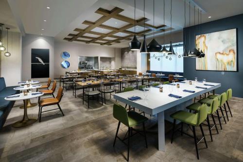 a restaurant with tables and chairs in a room at Hilton Garden Inn Sunnyvale in Sunnyvale
