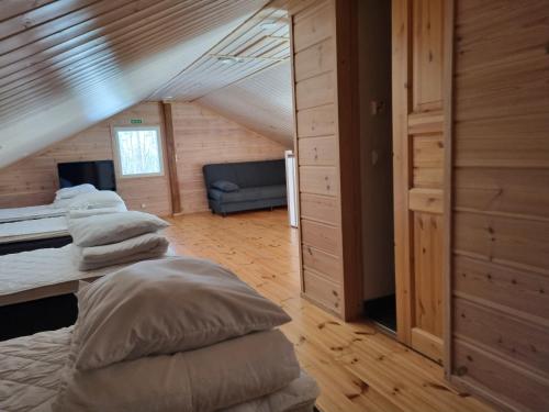 a bedroom with three beds in a attic at Villa Tumppu in Muurame