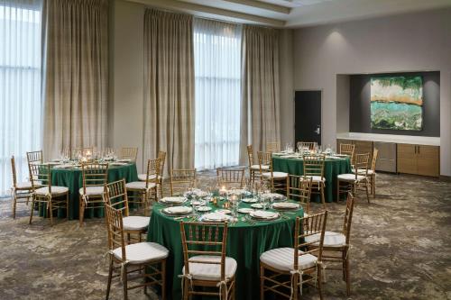 a room with tables and chairs with green tablecloths at Hilton Garden Inn Sunnyvale in Sunnyvale