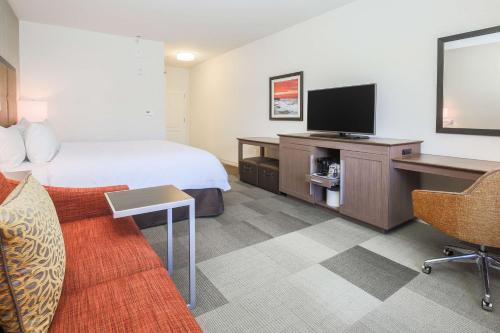 a hotel room with a bed and a flat screen tv at Hampton Inn & Suites Camarillo in Camarillo