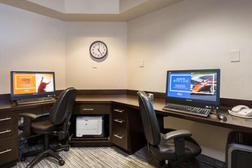 an office cubicle with two computer monitors on a desk at Hampton Inn & Suites San Diego-Poway in Poway