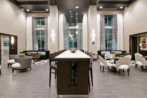 a lobby with chairs and tables and a waiting room at Hampton Inn & Suites Bellevue Downtown/Seattle in Bellevue