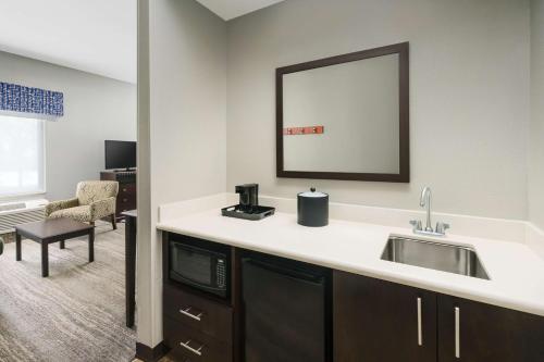 a kitchen with a sink and a mirror at Hampton Inn & Suites West Sacramento in West Sacramento