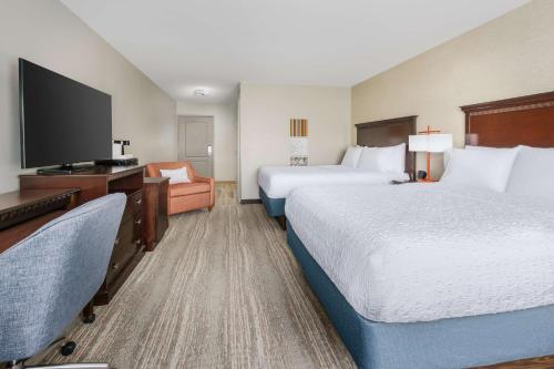 a hotel room with two beds and a flat screen tv at Hampton Inn & Suites Thousand Oaks in Thousand Oaks