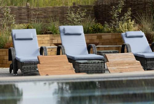 a couple of chairs and a table and some water at Barton Hall Hotel & Spa in Kettering
