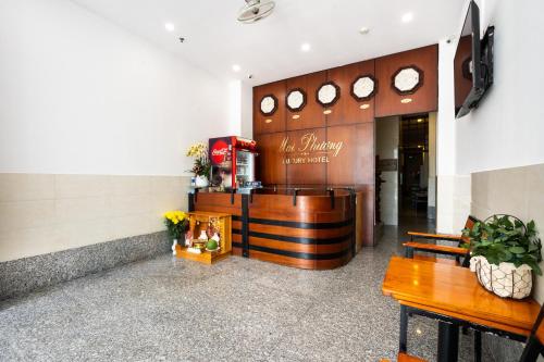 a lobby with two benches and a counter at Mai Phương - RUBY SAIGON HOTEL in Ho Chi Minh City