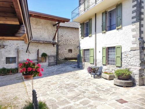 a courtyard of a building with a bench and flowers at Il Bosco di Silvia in Bosco