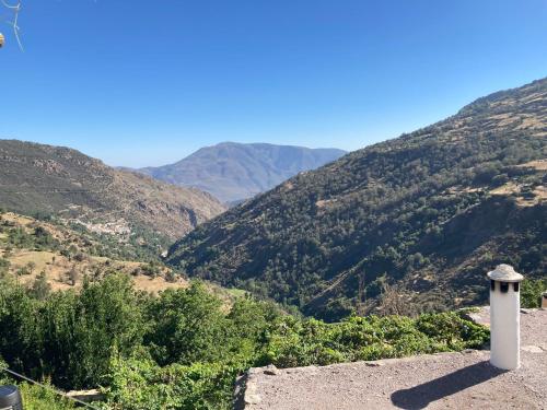 a view of a valley with mountains in the background at Casa Tradicional Alpujarreña in Capileira