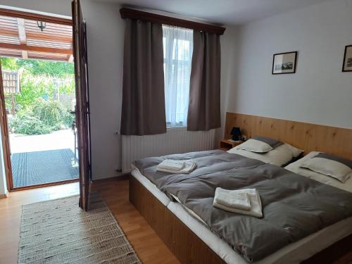 A bed or beds in a room at Kazsimér Vendégház