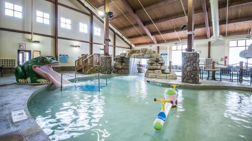 a indoor swimming pool with a water slide in a building at Christmas Mountain Campground in Wisconsin Dells