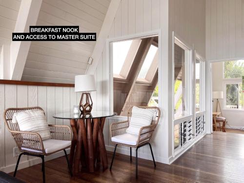 a dining room with a table and two chairs at Anahola Aloha Beach House home in Anahola
