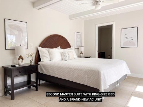 a bedroom with a large bed and astandway assay act unit at Anahola Aloha Beach House home in Anahola